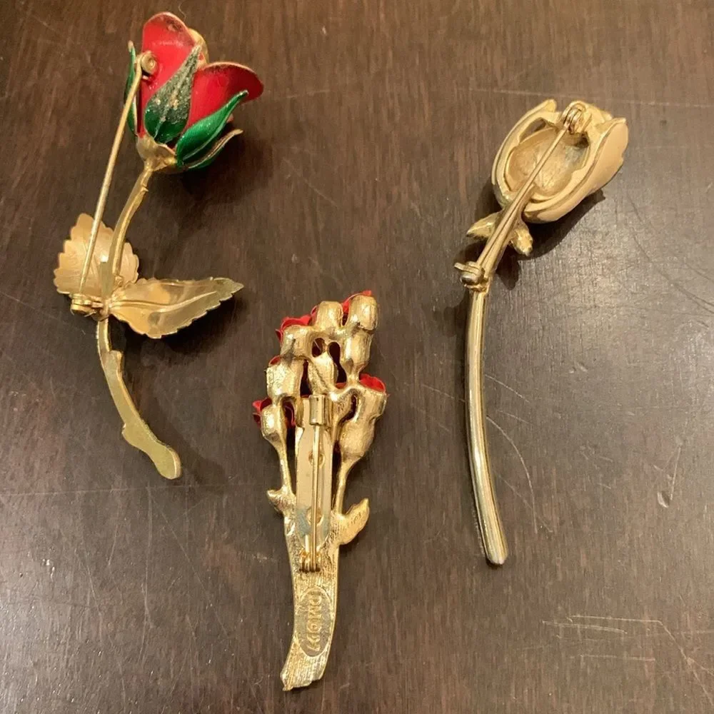 Three vintage rose brooches